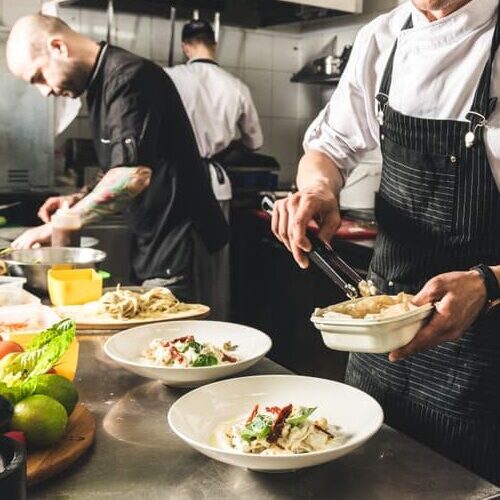 Chefs working in the commercial kitchen at The Point Restaurant, serving vegan dishes ready for guests